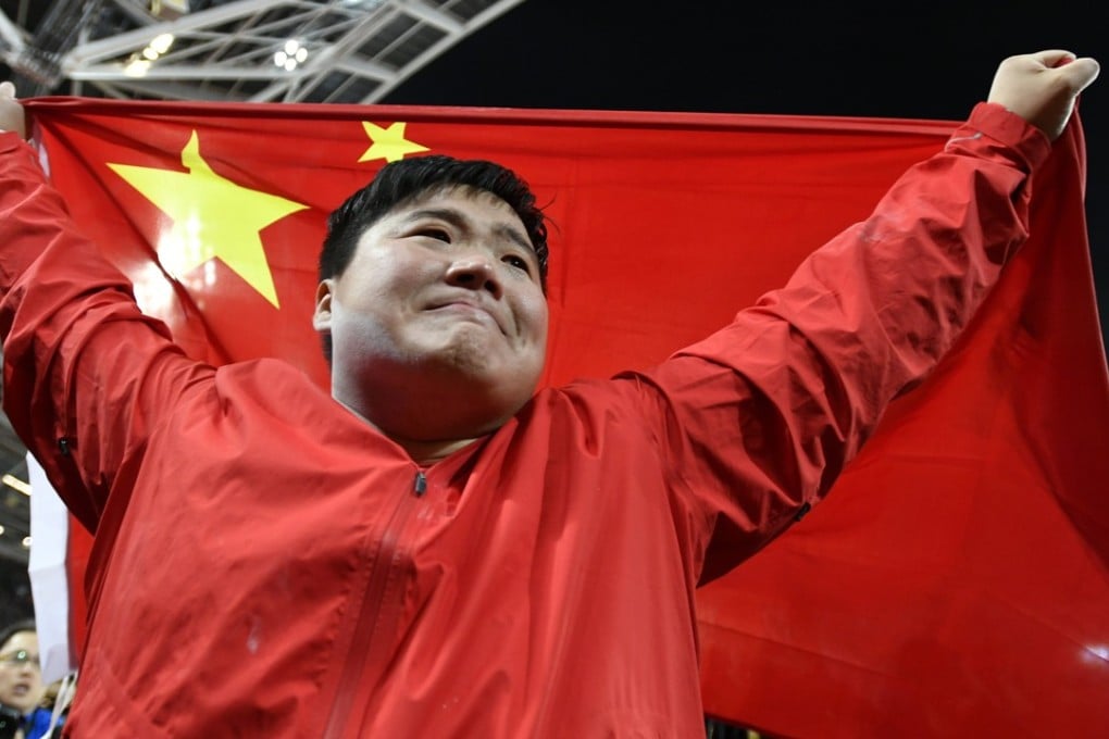 Gold medallist Lijiao Gong of China celebrates with her country’s flag after winning the shot put final at the London 2017 IAAF World Championships. Photo: EPA