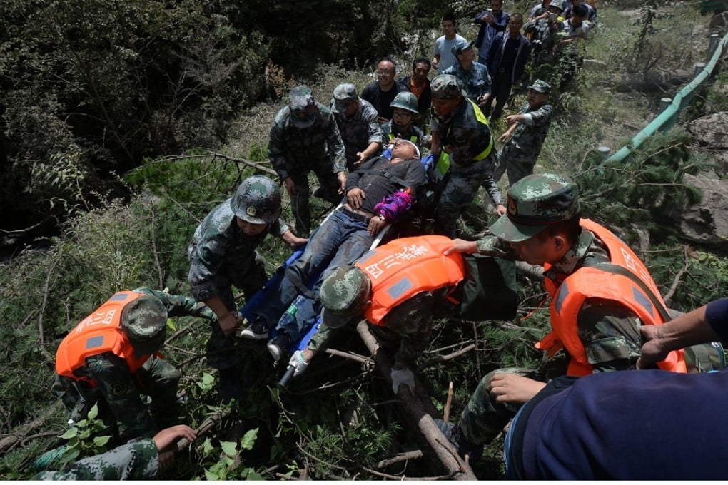 Paramilitary police carry a survivor to safety after the earthquake in Jiuzhaigou county on Tuesday night. Photo: Reuters