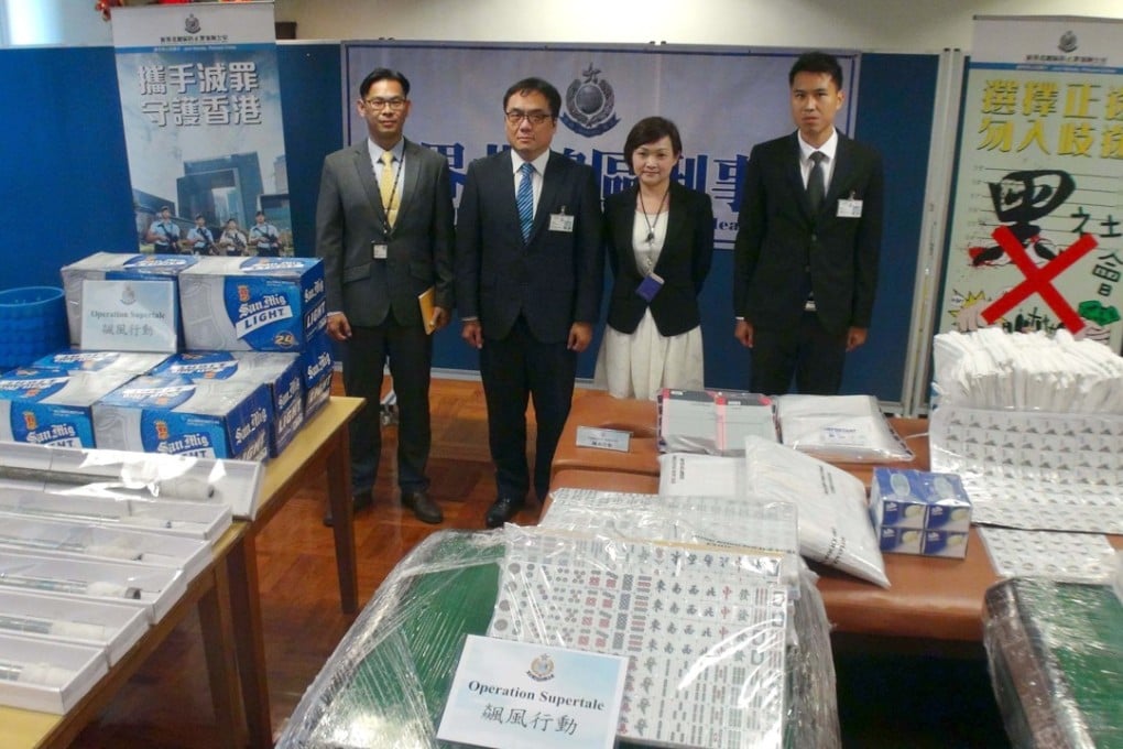 Police with items seized during the series of raids carried out this week. Photo: Handout