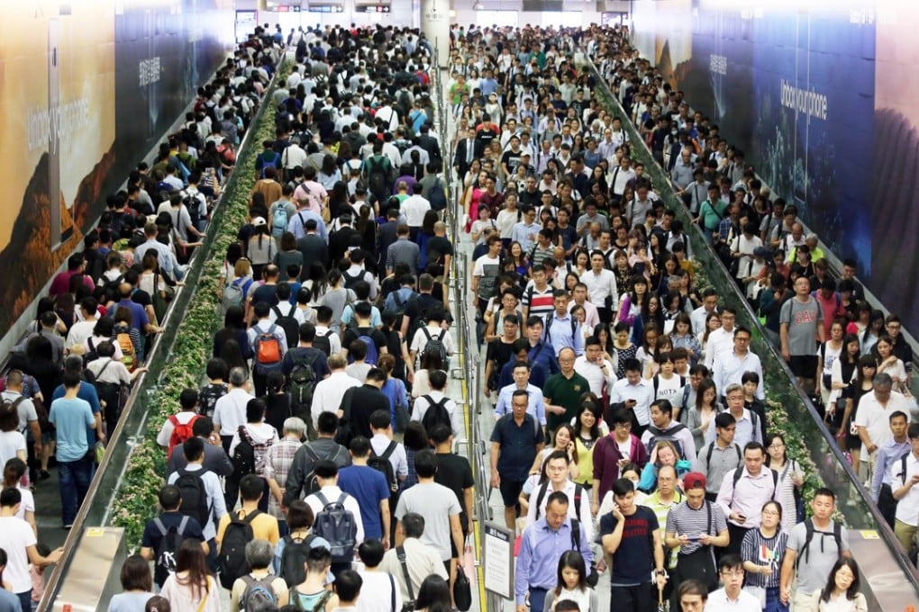 People rushing home at Cental MTR Station after the Typhoon No. 8 signal was hoisted on June 12. Typhoon Merbok edged towards Hong Kong and the China's south coast on 12 June, bringing strong winds and rough seas, with the Hong Kong observatory raising its third-highest typhoon warning signal. Photo: SCMP/ Dickson Lee