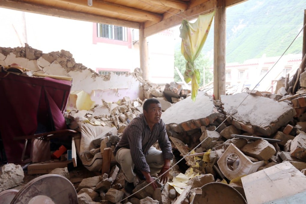 Liumeijie sifts through the rubble of his home in the town of Zhangzha. Photo: Sam Tsang