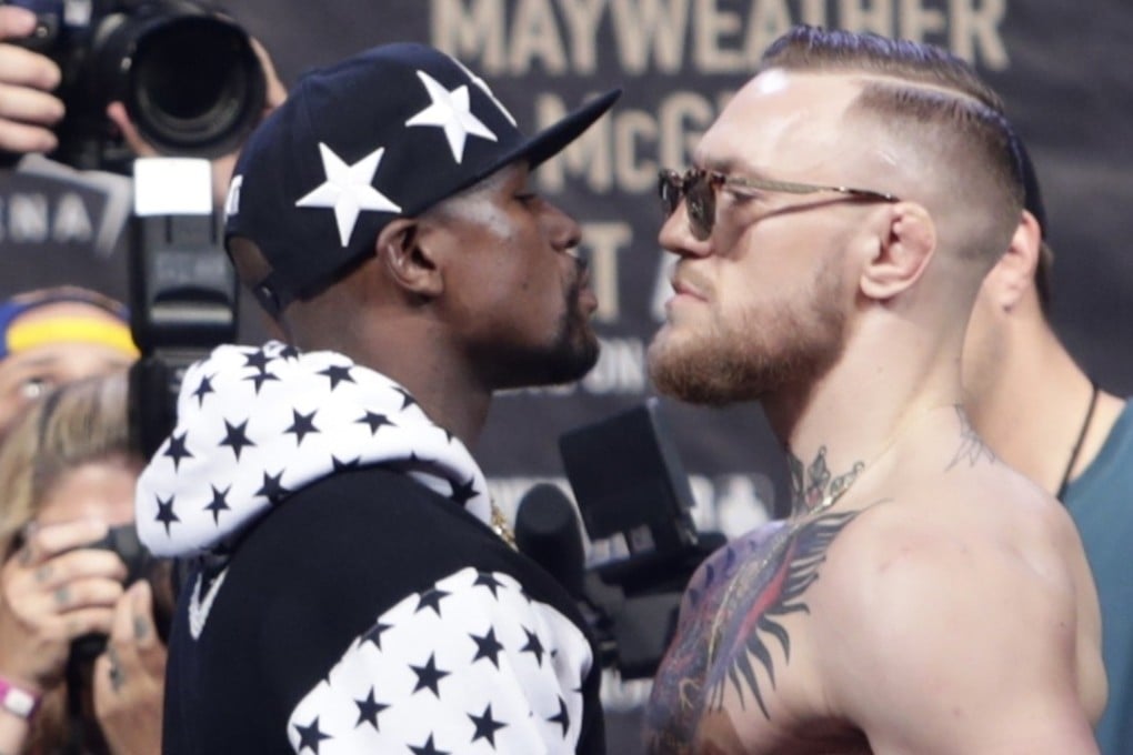 Floyd Mayweather Jnr (left) and Conor McGregor face off for photos during a news conference at Barclays Centre in New York. Photo: AP
