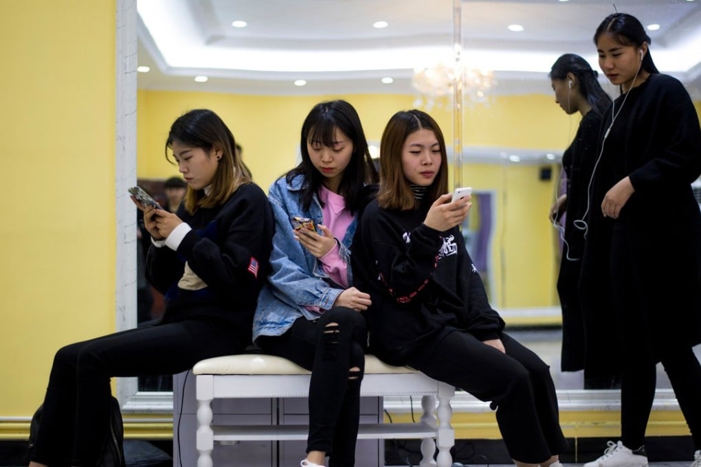 Students looking at their smartphones during a class at the Yiwu Industrial & Commercial College in Yiwu, east China's Zhejiang Province. Hordes of Chinese millennials are speaking directly to the country's 700 million smartphone users, streaming their lives to lucrative effect, fronting brands and launching businesses. They are known as "wanghong" -- literally hot on the web -- and they now represent a multi-billion-dollar industry, becoming so big that it has its own university curriculum. At Yiwu Industrial & Commercial College, classrooms for the 34 mostly female students are typically dance studios, catwalks strafed by flashing lights, and bustling makeup rooms. Photo: AFP