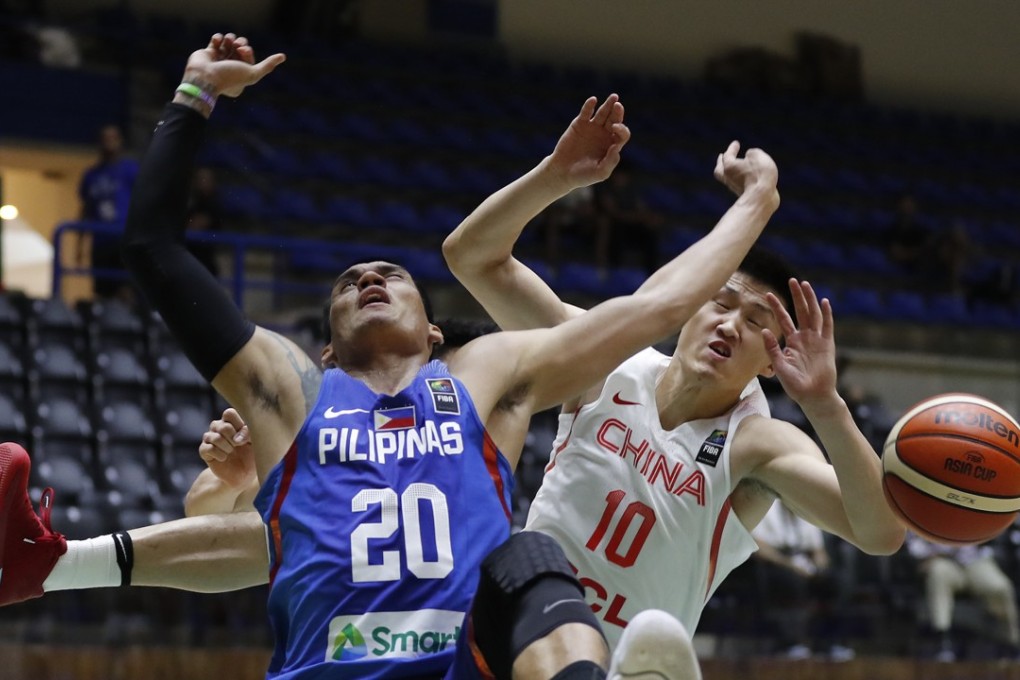 The Philippines’ Raymond Almazan (left) challenges for the ball against China’s Zhou Peng during their Fiba Asia Cup match at Nouhad Nawfal Sports Complex in Lebanon on Wednesday. Photo: AP