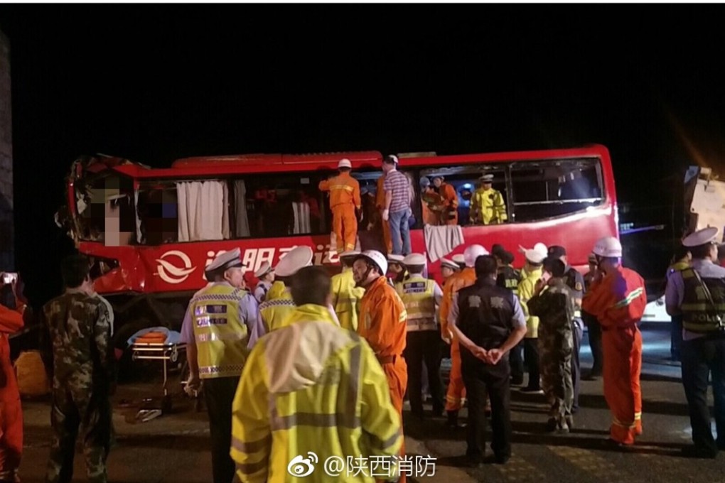 The emergency services examine the wreckage of the coach. Photo: Weibo