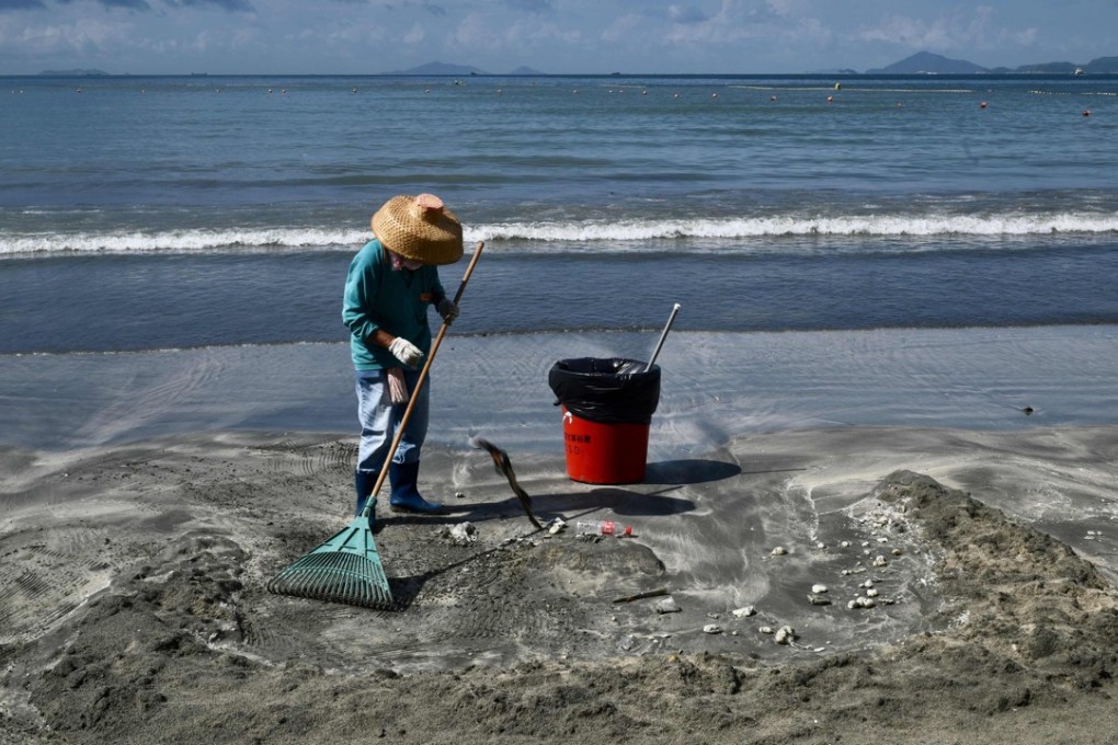 A cleaner at work on a Hong Kong beach. Under Hong Kong law, only employees engaged under a continuous contract are entitled to most benefits, including sick leave, annual leave, rest days, maternity and paternity leave and pay, end-of-year bonus, and the right to claim unreasonable dismissal. Photo: AFP