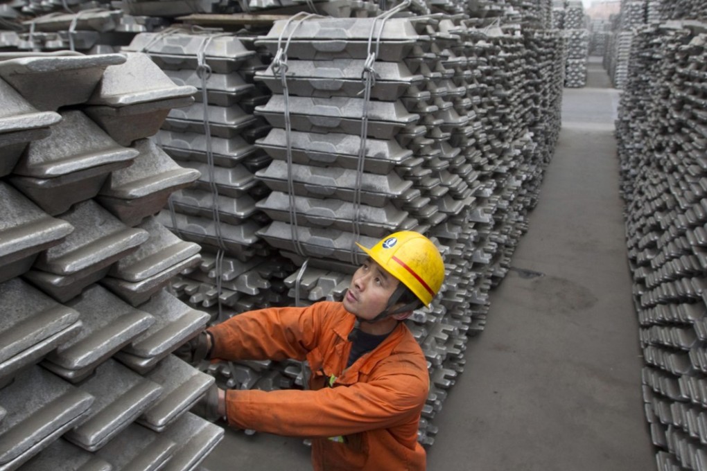 An employee checks aluminium ingots destined for export. Photo: Reuters