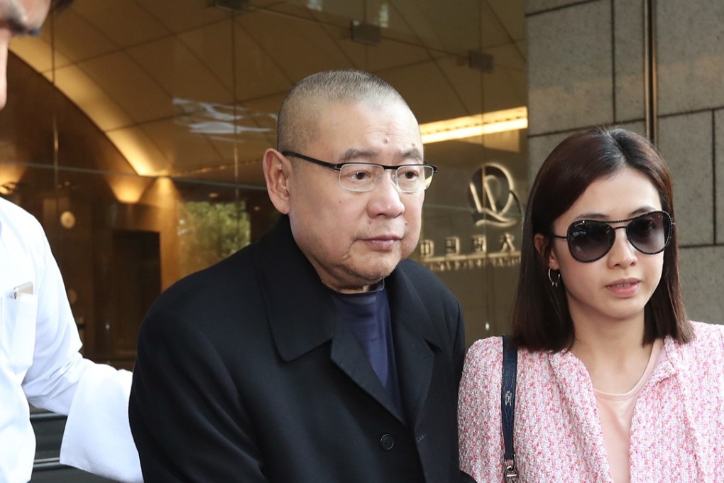 Joseph Lau Luen-hung (centre) and his wife Chan Hoi-wan leave China Evergrande Centre in Wan Chai in March. Lau has announced he had transferred his entire controlling stake in Chinese Estates, worth an estimated US$2.17 billion, to his wife and son, Lau Ming-wai. Photo: Edward Wong