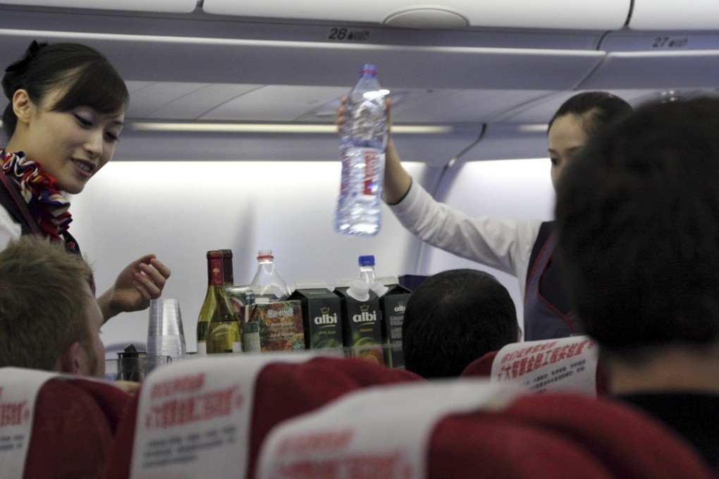 Flight attendants serve a meal on a flight. Sudden turbulence when you’re manning a 90kg food cart is one of the worst nightmares for cabin crew. Photo: Alamy