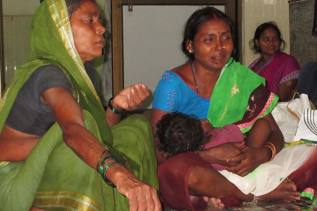 Relatives mourn the death of a child at Baba Raghav Das Hospital in Gorakhpur. Photo: AFP