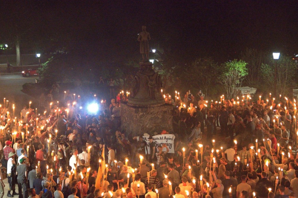 White nationalists carrying torches gather around a statue of Thomas Jefferson on the grounds of the University of Virginia, on the eve of the Unite The Right rally in Charlottesville, Virginia. Photo: Reuters