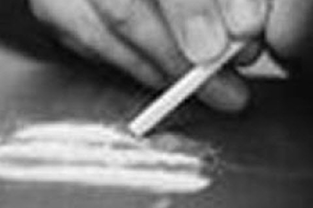 Lines of cocaine on a table with a hand holding a straw. Photo: Handout