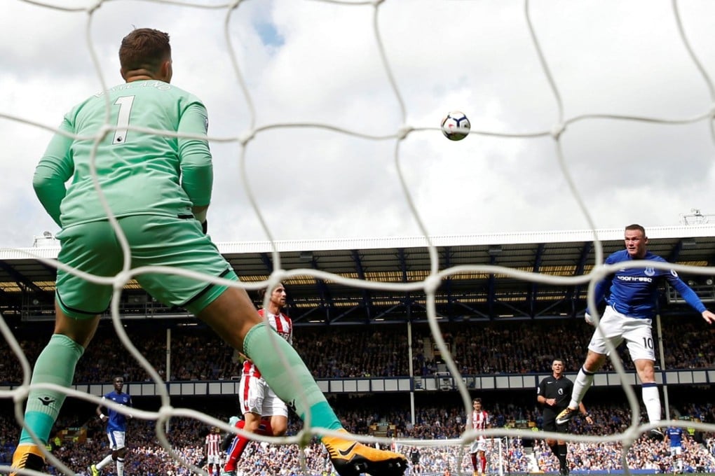 Wayne Rooney scores Everton’s winner against Stoke goalkeeper Jack Butland. Photo: Reuters