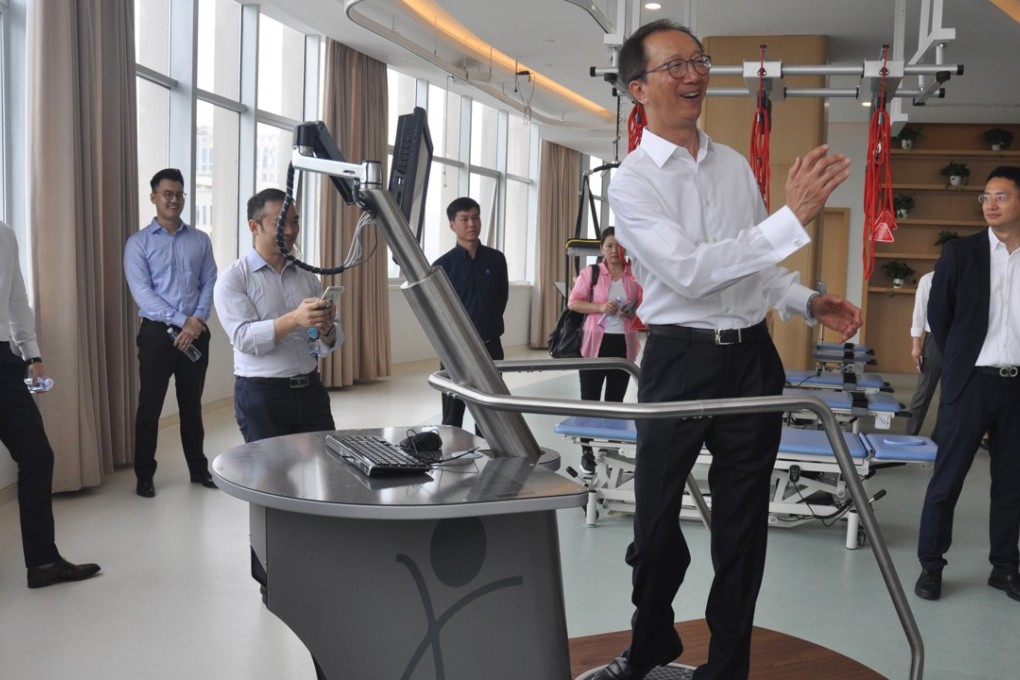 Antony Leung tries out a rehabilitation device at the Care Alliance Rehabilitation Hospital in Chengdu. Photo: Elizabeth Cheung