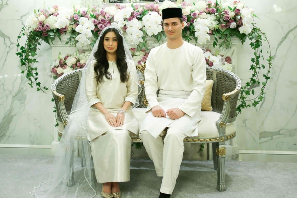 Dennis Muhammad Abdullah of the Netherlands posing with his bride, Princess Tunku Tun Aminah Sultan Ibrahim. Photo: AFP