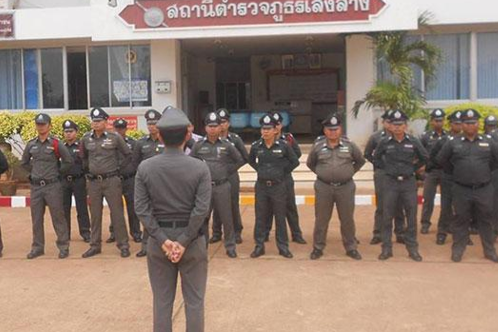 Police at Soeng Sang police station listen to an address by their supervisor after observing the national anthem at 8am. Photo: Prasit Tangprasert/Bangkok Post