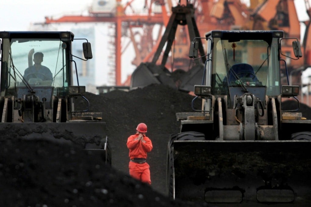 A worker surveys coal imported from North Korea at Dandong port on China’s border with North Korea. Photo: Reuters