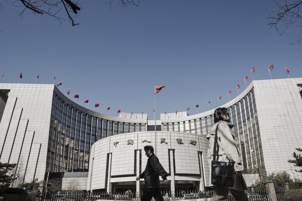 Pedestrians walk past the People's Bank of China (PBOC) headquarters in Beijing, China, on Thursday, March 9, 2017. China's central bank plans to apply a stricter method for assessing banks' capital as part of efforts to contain financial-sector risks, people with knowledge of the matter said. Photo: Bloomberg