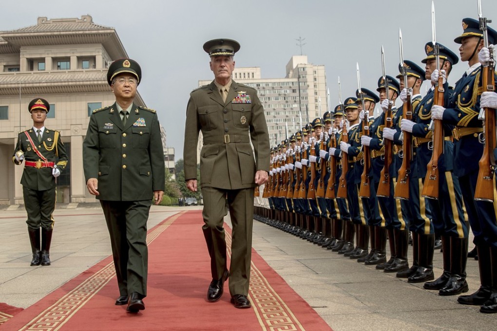 PLA General Fang Fenghui (left) accompanies US Joint Chiefs Chairman General Joseph Dunford during a welcome ceremony at the Bayi Building in Beijing on Tuesday. Photo: AP