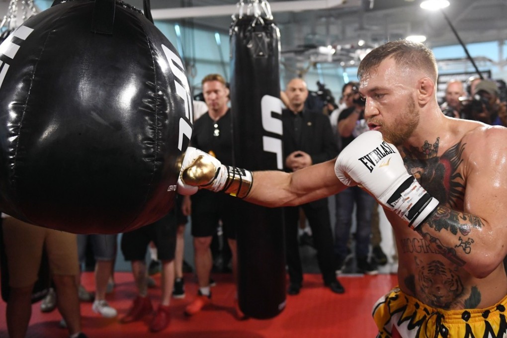 UFC lightweight champion Conor McGregor hits an uppercut bag during a media workout. Fight promoter Bob Arum says the Irishman will be hopelessly out of his depth against Mayweather. Photo: AFP