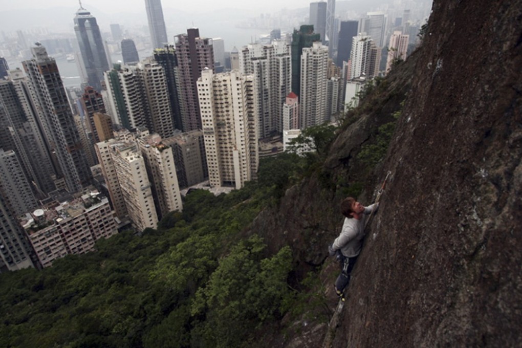 A climber ascends a rock face in Hong Kong’s Central district. Photo: Stuart Millis