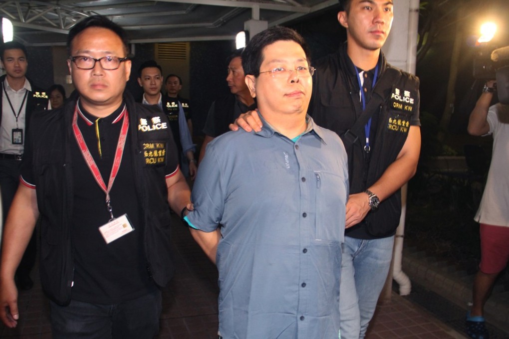 Police escort Howard Lam after his arrest early on Tuesday morning. Photo: Handout