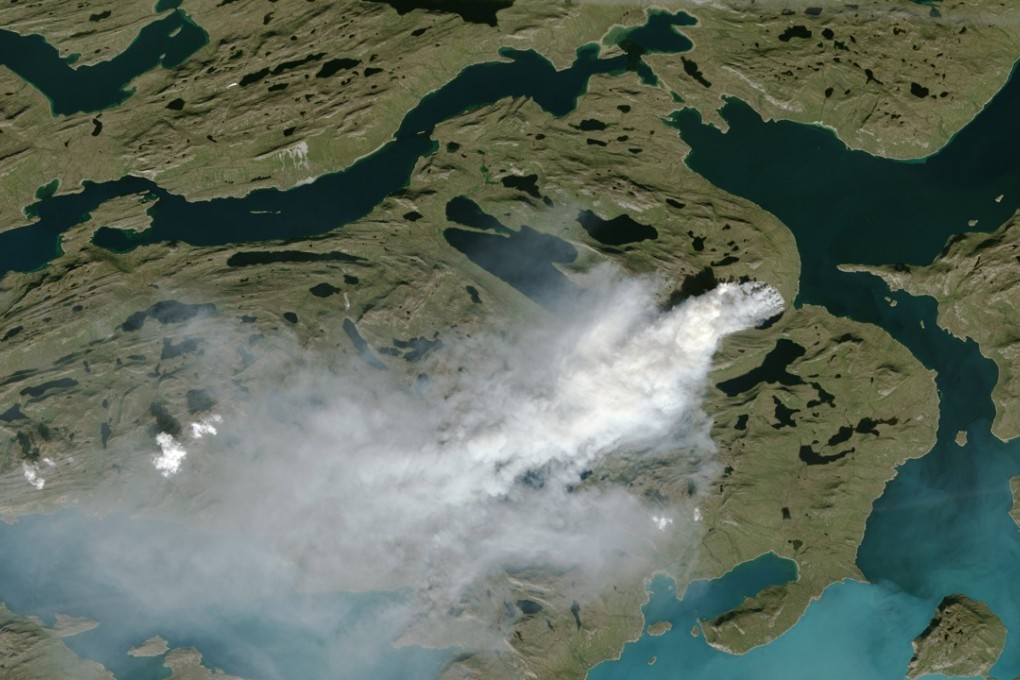 This NOAA handout satellite photo taken on August 3, 2017 shows a cloud of smoke from wildfires burning in western Greenland, about 150 kilometres (90 miles) northeast of Sisimiut. Photo: NOAA handout via AFP