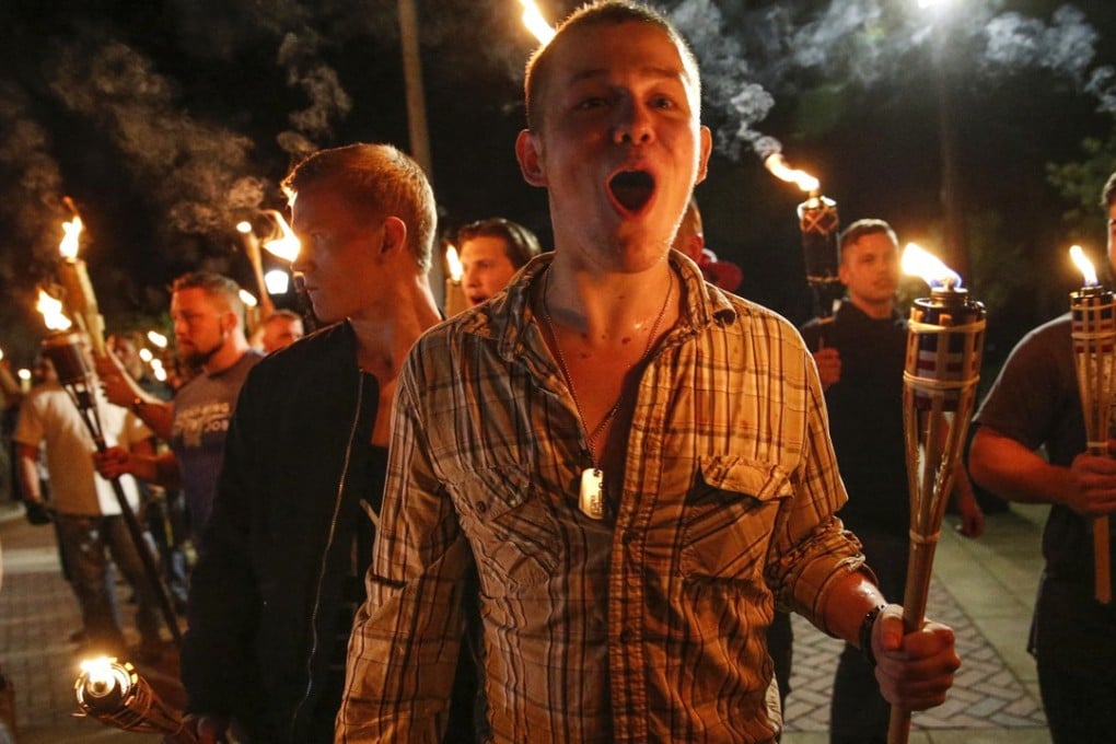 In this photo taken Friday, August 11, 2017, white nationalist groups march with torches through the University of Virginia campus in Charlottesville. Photo: AP