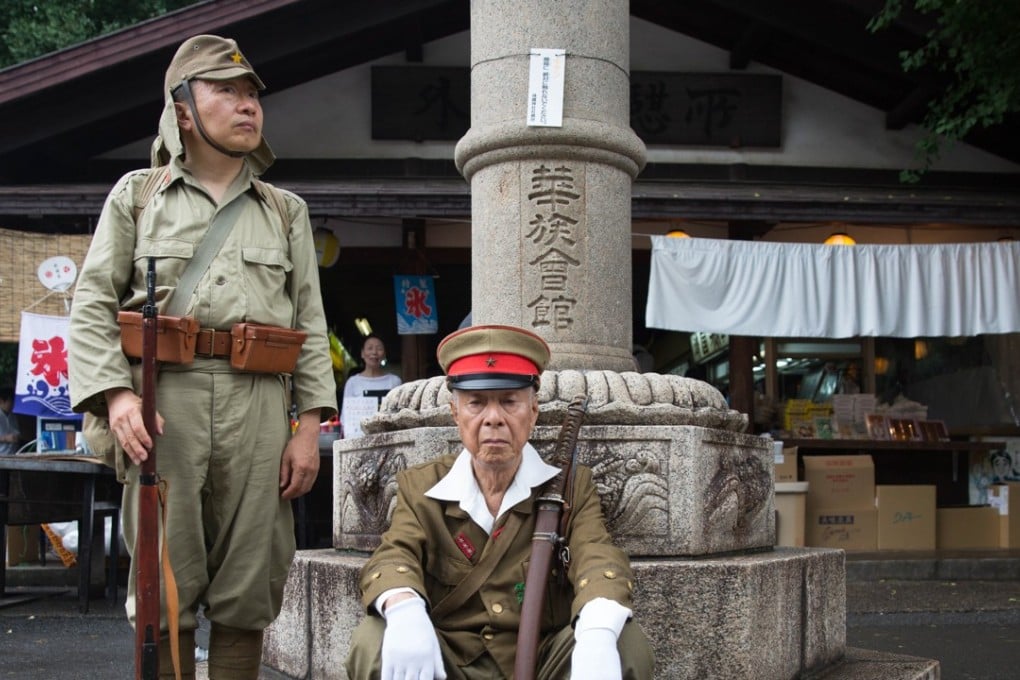 Japanese men wear imperial army uniforms at the Yasukuni Shrine in Tokyo. Photo: AFP