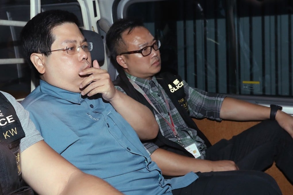 Howard Lam Tsz-kin escorted by police officers leaves at Kowloon West Regional Police Headquarters. Photo: Edward Wong