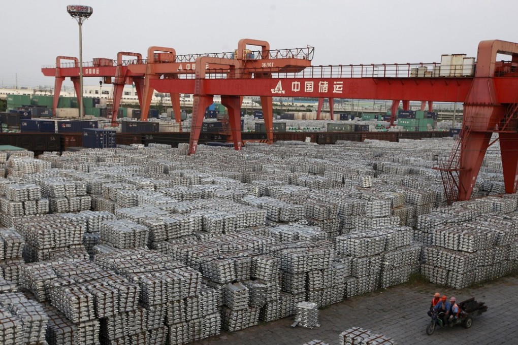 Workers ride on an motor rickshaw through an aluminium ingots depot in Wuxi, Jiangsu province in this September 26, 2012 file photo. China's aluminium and nickel producers have asked Beijing to buy up surplus metal, sources said, the first coordinated effort since 2009 to revive prices suffering their worst rout since the global financial crisis. Photo: Reuters