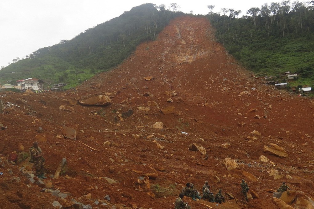 Security forces take a rest after searching for bodies at the scene of a massive mudslide in Regent, just outside Sierra Leone's capital, Freetown, on Tuesday. Photo: AP