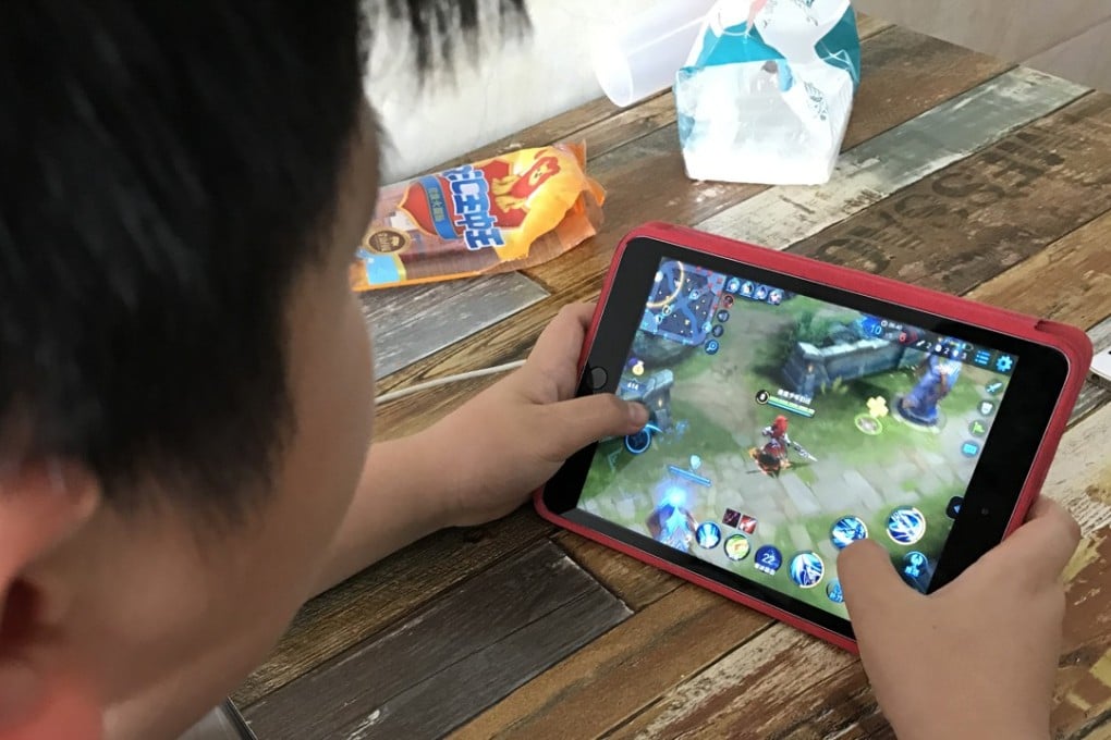 A boy plays Honour of Kings, the most popular multi-player online battle game owned by Tencent, in Qianxi county in Guizhou province. Photo: Simon Song