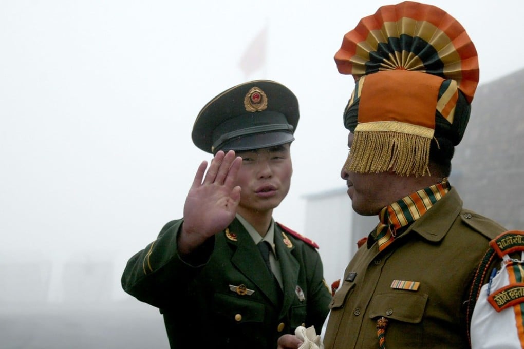 A Chinese soldier (L) gestures next to an Indian soldier at the Nathu La border crossing between India and China in India's northeastern Sikkim state. An altercation has broken out between Chinese and Indian troops. Photo: AFP