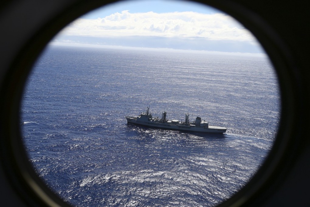 HMAS Success scans the southern Indian Ocean, near the coast of Western Australia, as a Royal New Zealand Air Force P3 Orion flies over, while searching for missing Malaysia Airlines Flight MH370. Photo: AP