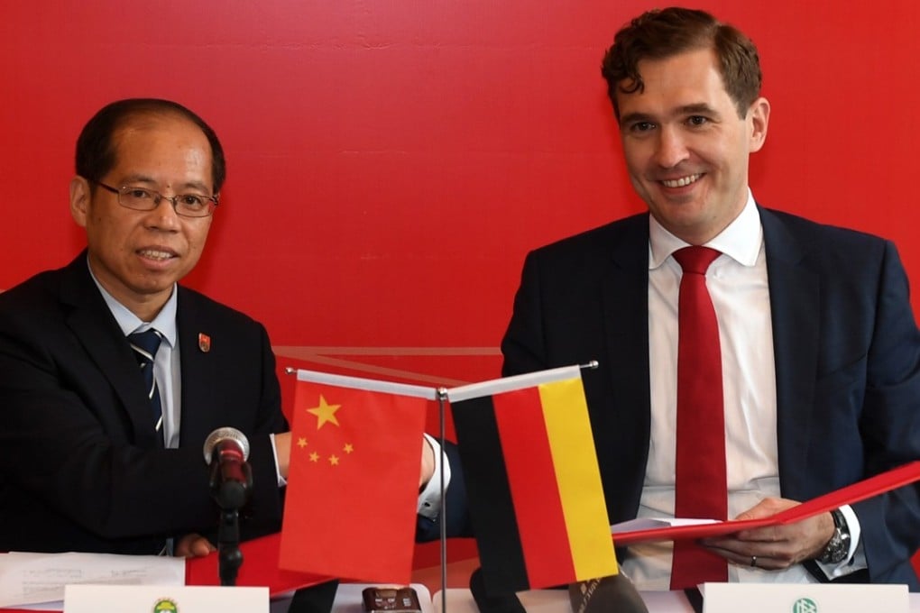 Chinese Football Association general secretary Zhang Jian and German counterpart Friedrich Curtius signing the agreement in Beijing. Photo: Xinhua