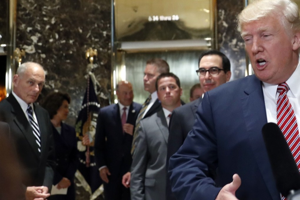 White House chief of staff John Kelly, left, watches as US President Donald Trump speaks to the media in the lobby of Trump Tower on Tuesday in New York. Behind Trump’s shoulder is Treasury Secretary Steve Mnuchin. Photo: AP
