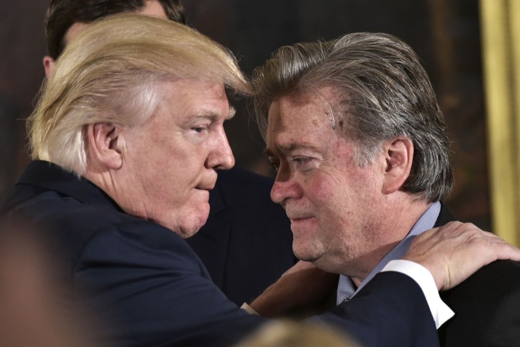 Donald Trump talks to Steve Bannon during a swearing-in ceremony for senior staff at the White House on January 22. Picture: AFP
