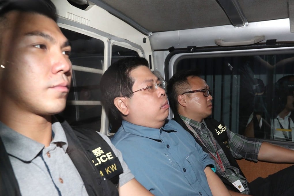 Howard Lam (centre) is escorted by police officers after his arrest on Tuesday morning. Photo: Edward Wong