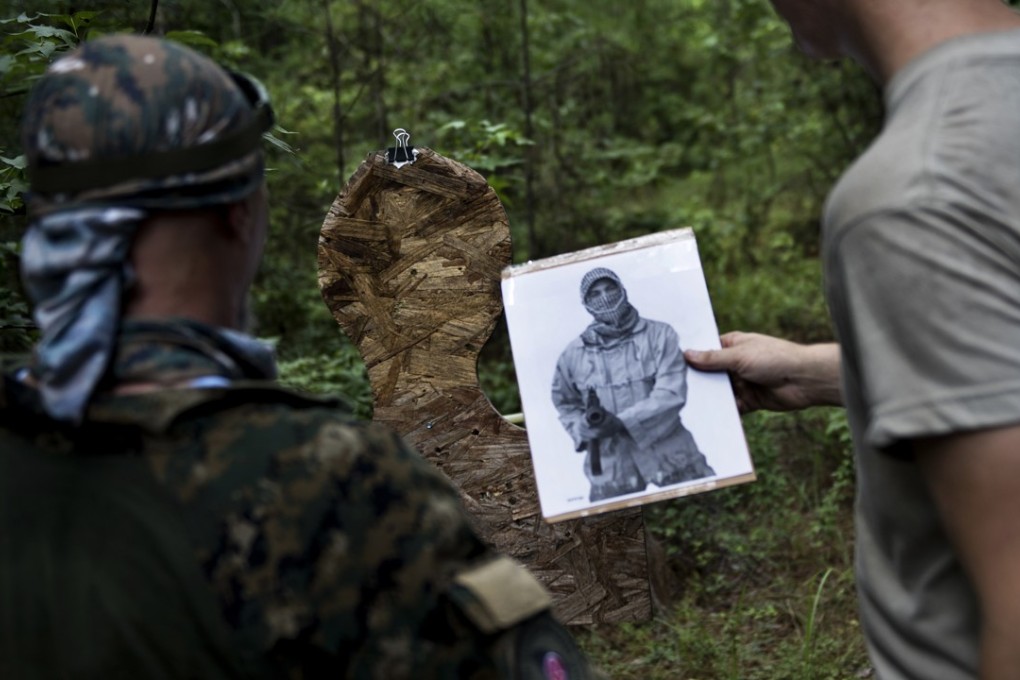 Members of the Georgia Security Force militia puts targets up before the group participates in live fire training. Photo: AFP