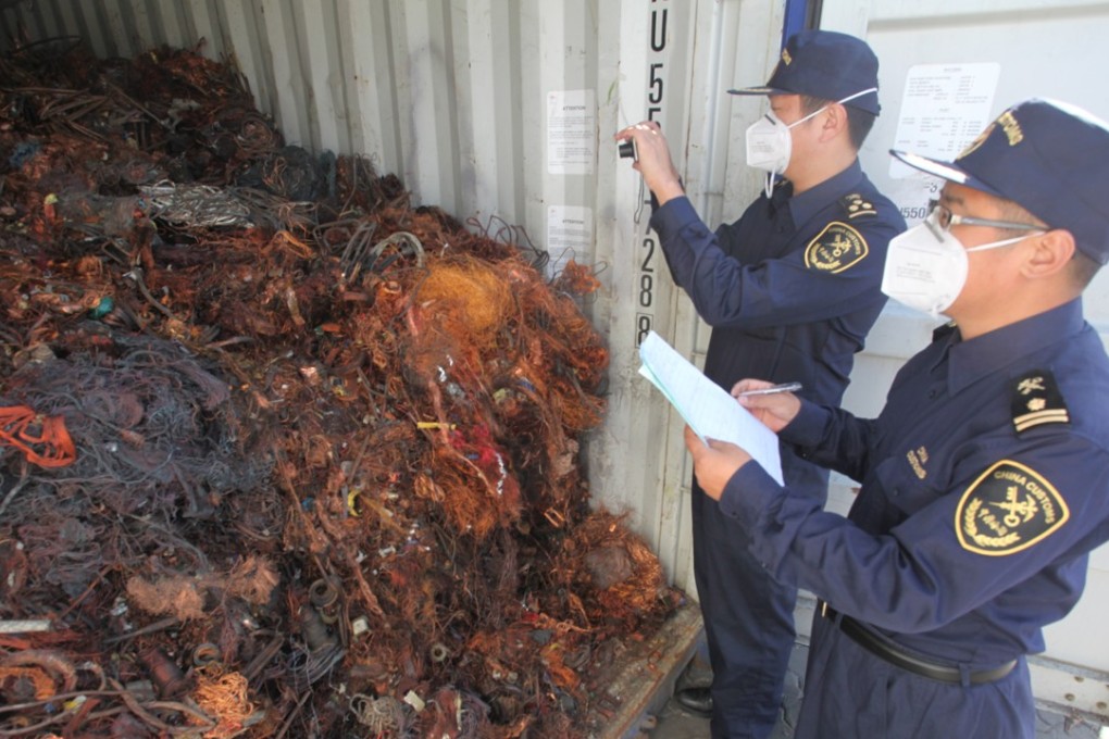 A file picture of customs officers checking imported foreign waste metal at a port in Qingdao in Shandong province. Photo: China Foto Press
