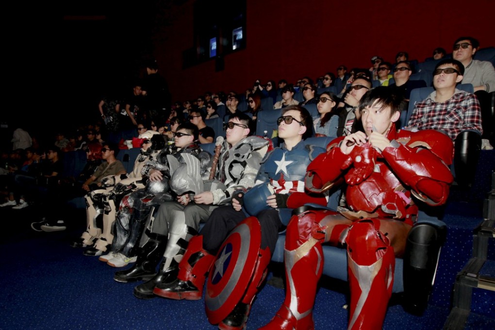 A group of fans dressed in home made replica armour of characters from "The Avengers: Age of Ultron": Iron Man, Captain America and Thor, watch the film in a theatre in Changchun in Jilin province on May 16, 2015. Photo: REUTERS