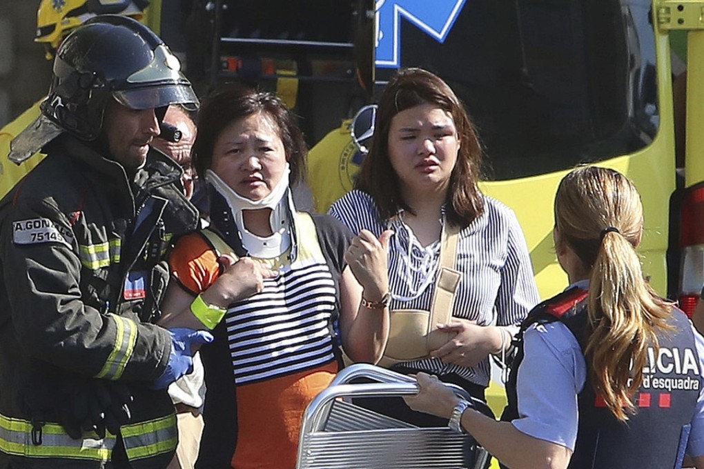Injured people are treated in Barcelona, Spain, Thursday, August 17, 2017 after a white van jumped the sidewalk in the historic Las Ramblas district, crashing into a summer crowd of residents and tourists and injuring several people, police said. Photo: AP