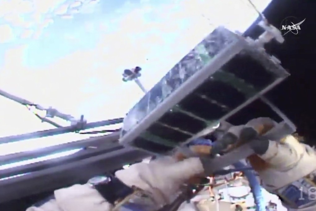 In this image made from video provided by Nasa, Russian cosmonaut Sergei Ryazansky holds a mini satellite before launching it by hand from the International Space Station on Thursday, August 17, 2017. Photo: Nasa via AP