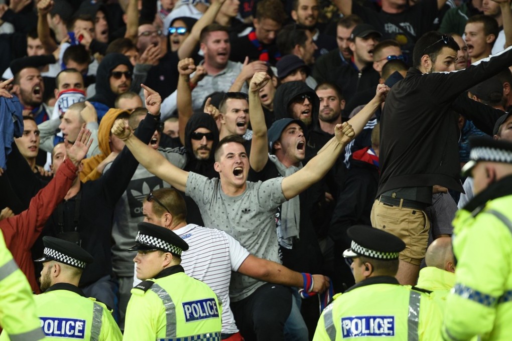 Hajduk Split supporters are held back by police and stewards at Goodison Park. Photo: AFP