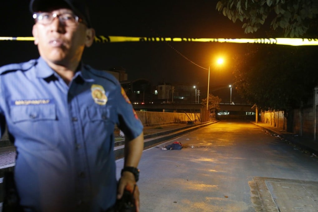 A police officer stands near the body of a crime suspect after he was killed in a shoot-out with police. Photo: AP