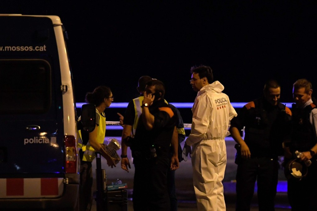 Policemen check the area after police killed five attackers in Cambrils near Tarragona. Photo: AFP