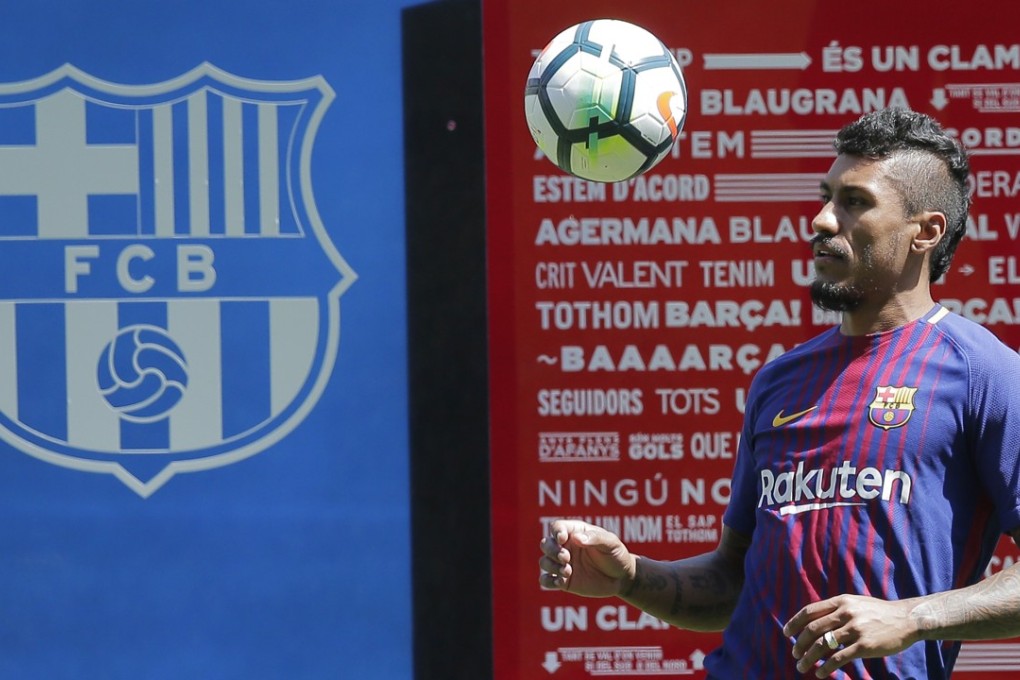 Barcelona’s new signing Paulinho controls a ball during his official presentation at the Nou Camp. Photo: AP