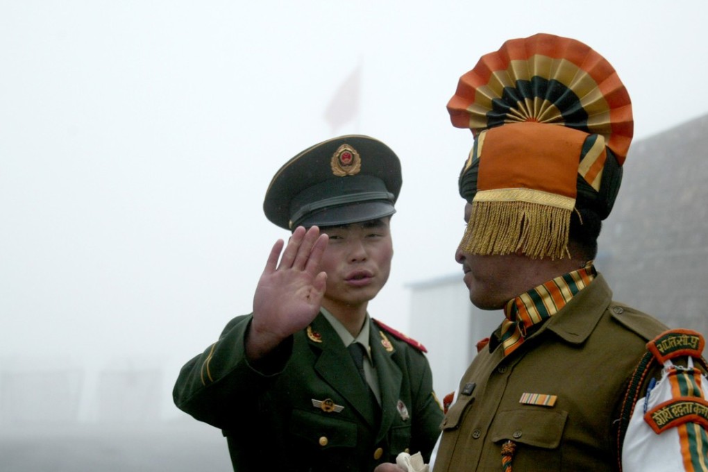A Chinese soldier gestures as he stands near an Indian soldier on the Chinese side of the ancient Nathu La border crossing between India and China. Photo: AFP