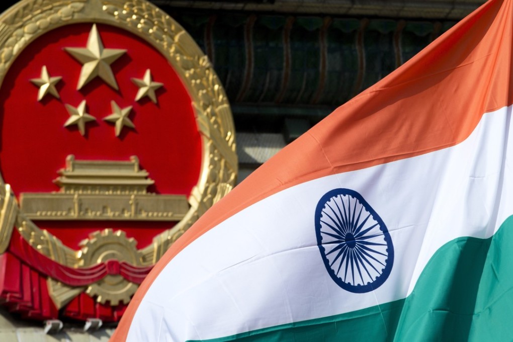 A Chinese emblem and an Indian flag at the Great Hall of the People in Beijing. Photo: AP